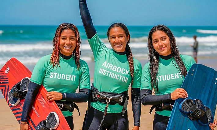Girls on beach with kitesurfing gear